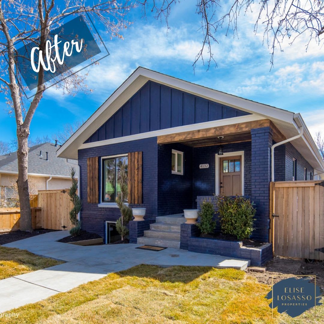 The house now features dark blue brick on the lower half and dark blue horizontal siding on the upper gable, accented by white trim and a white foundation.