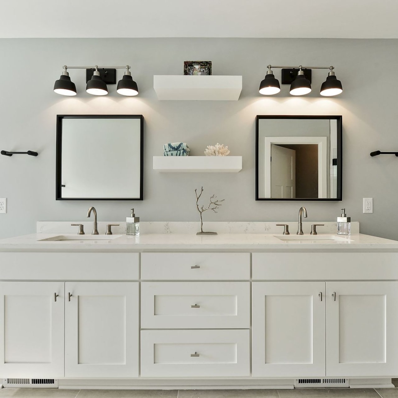 A double bathroom vanity with two sinks and a mirror above each sink.