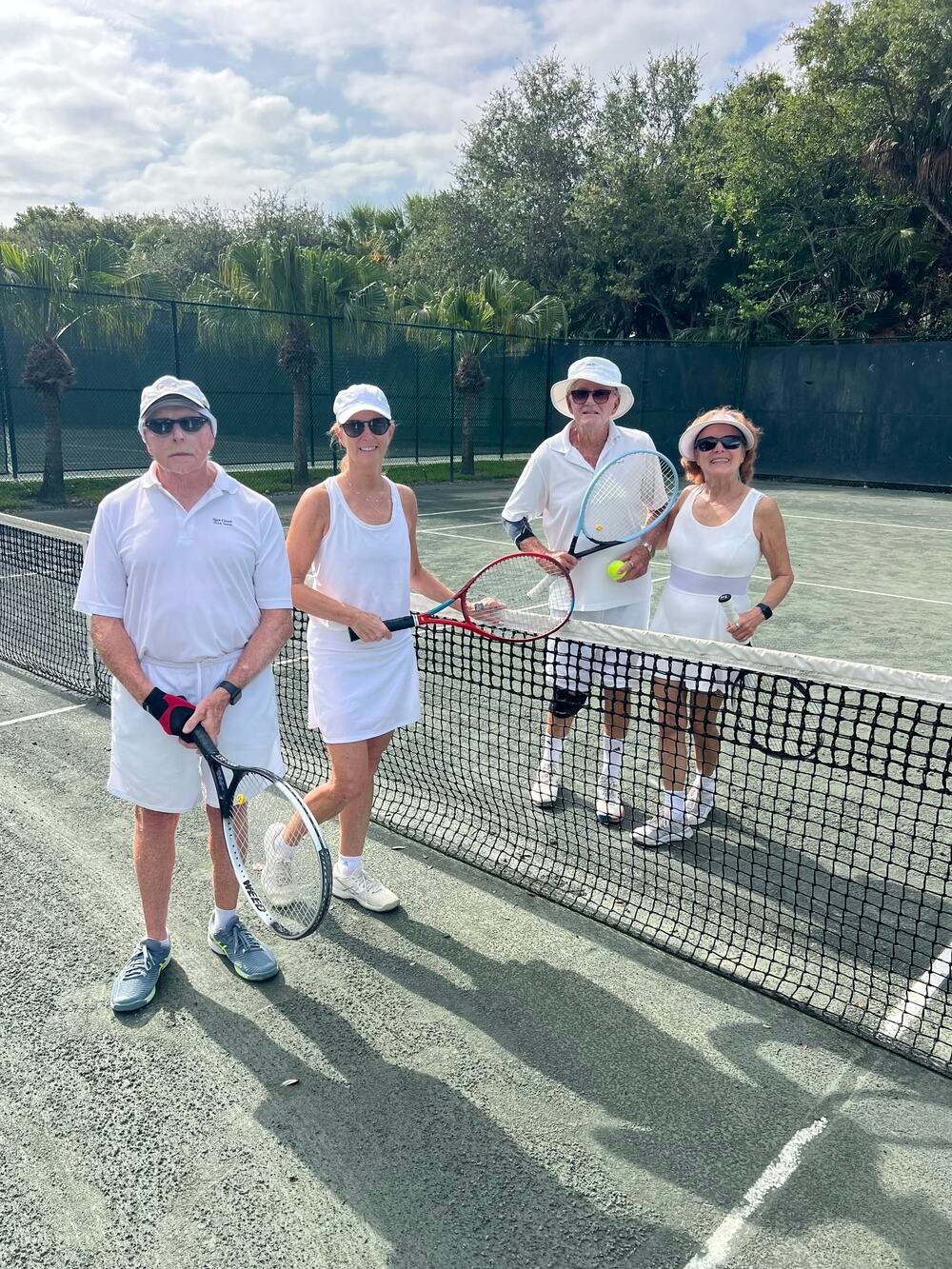 Residents playing doubles on the Har-Tru clay tennis courts at Sea Oaks Beach and Tennis Club in Vero Beach