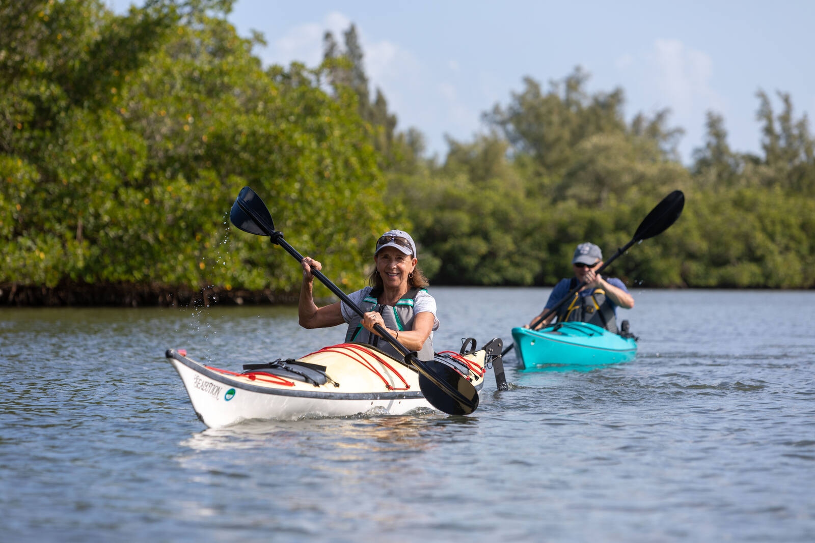 Two kayakers paddling the Indian River Lagoon mangroves beside the Sea Oaks community in Vero Beach