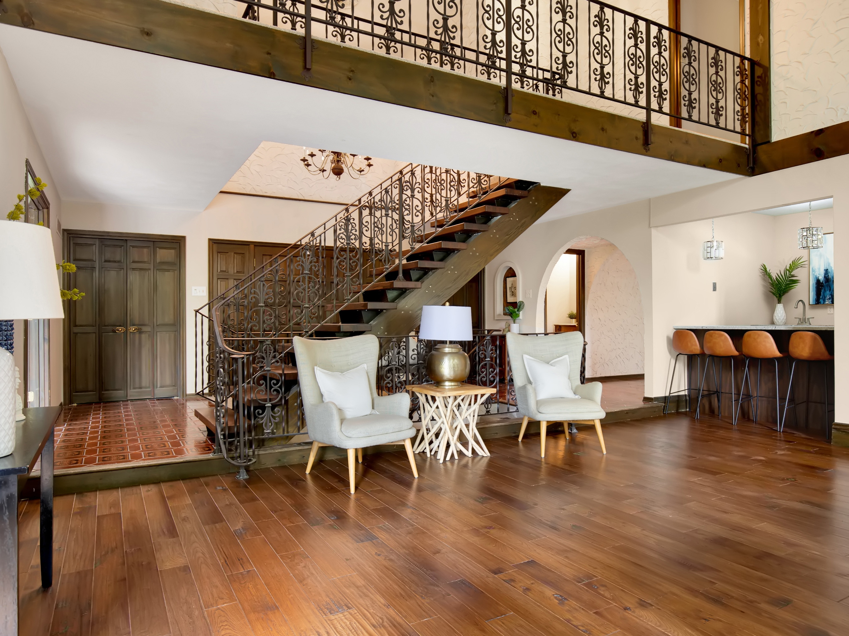 Two-story entry hall with iron staircase in a home sold by Alyssa Suntrup