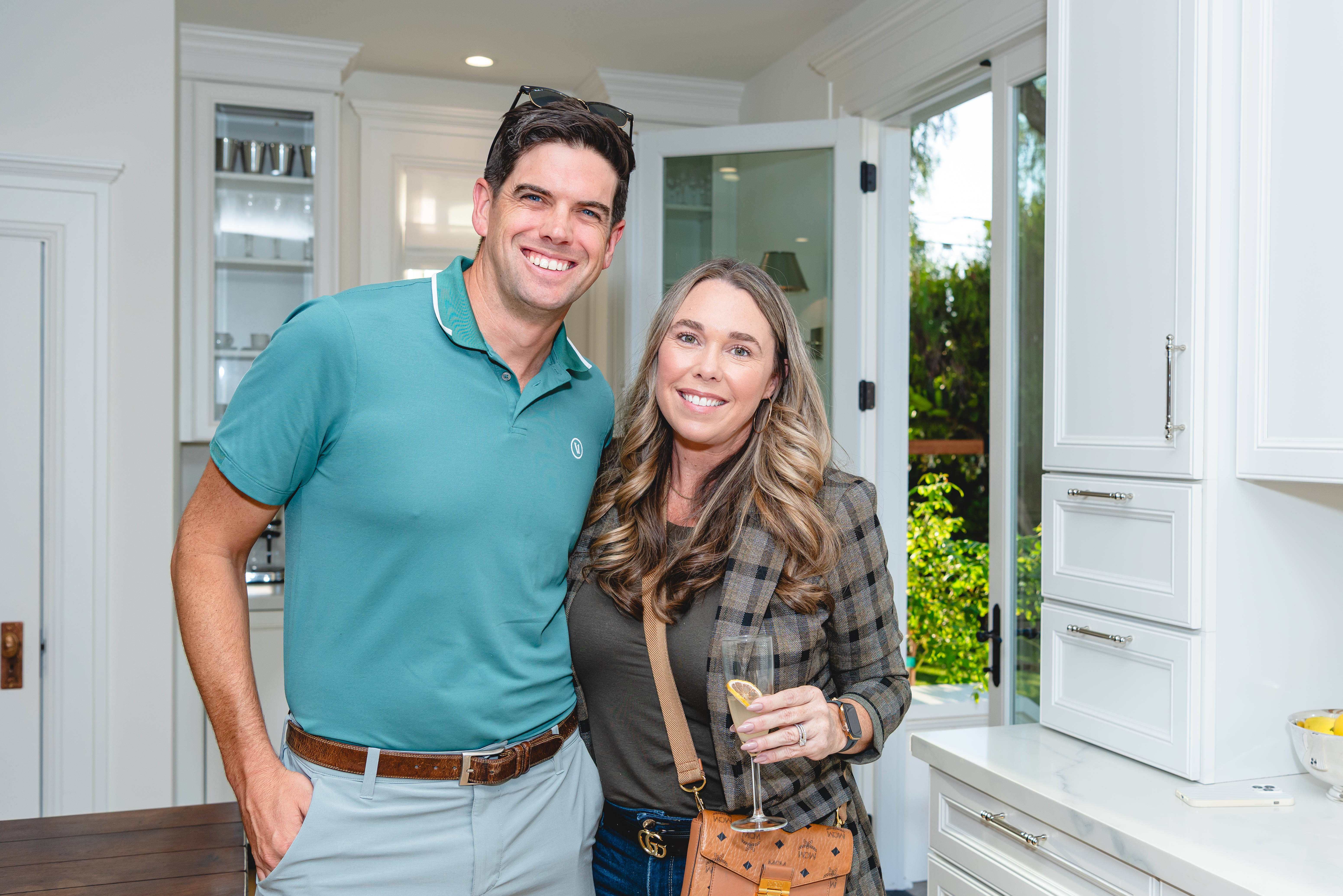 Couple smiling beside the kitchen cabinetry