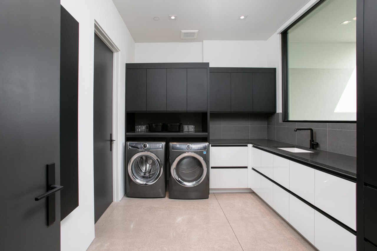 Luxury laundry room with built in shelves