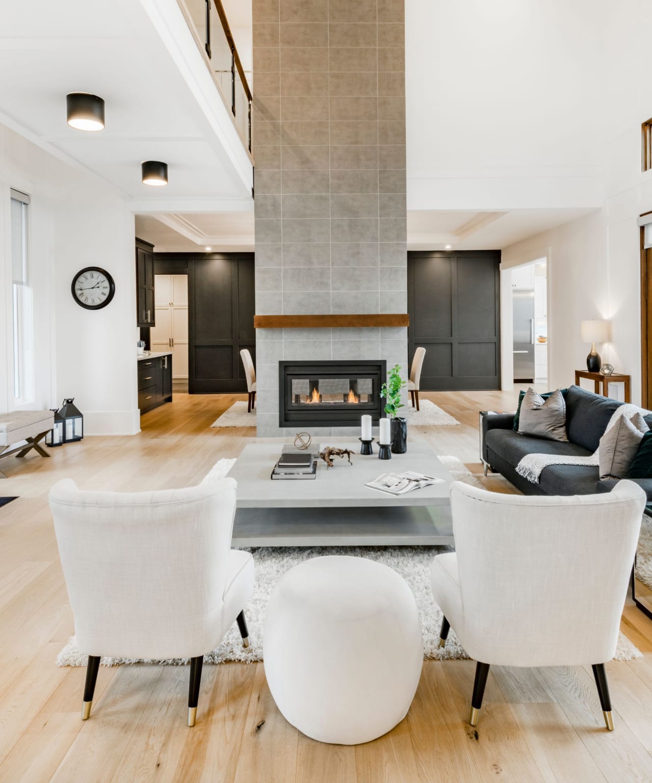 A luxury home with living room featuring a fireplace, a couch, and chairs.