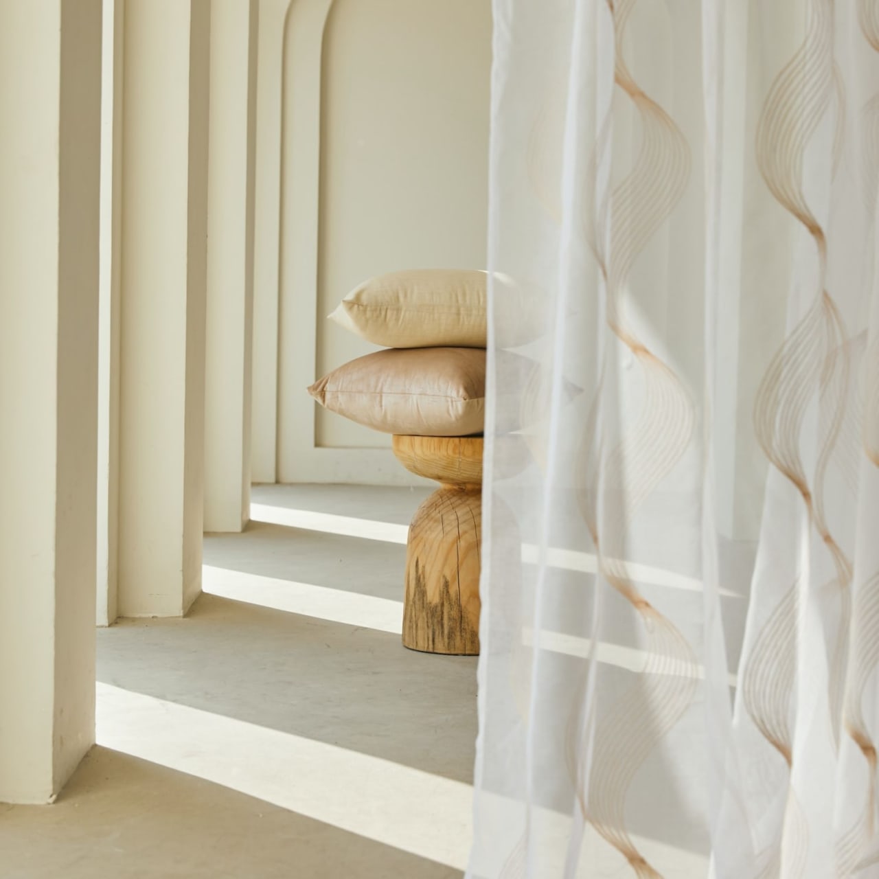 A stack of pillows on top of a wooden stool