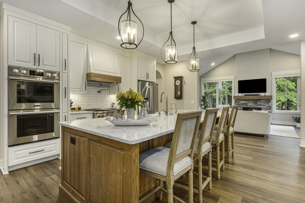 A kitchen with a large island and stool