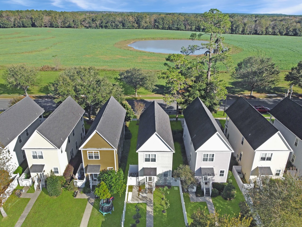 An aerial view of a row of houses in a residential neighborhood, showcasing the layout and design of the homes.