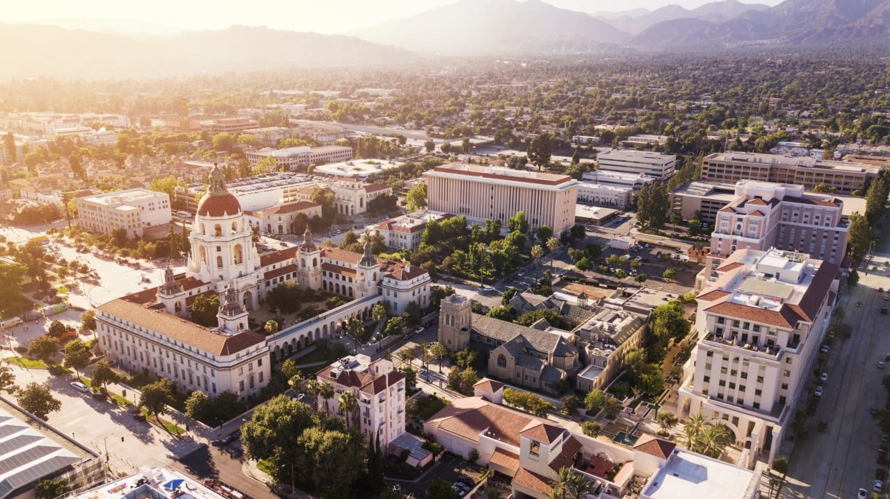 Serene aerial panorama of a vibrant city bathed in warm sunlight.