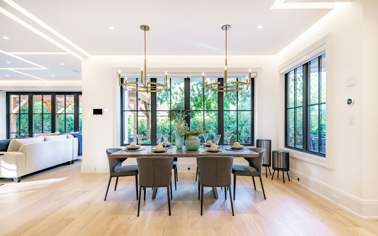 A modern dining room with a large wooden table and six chairs