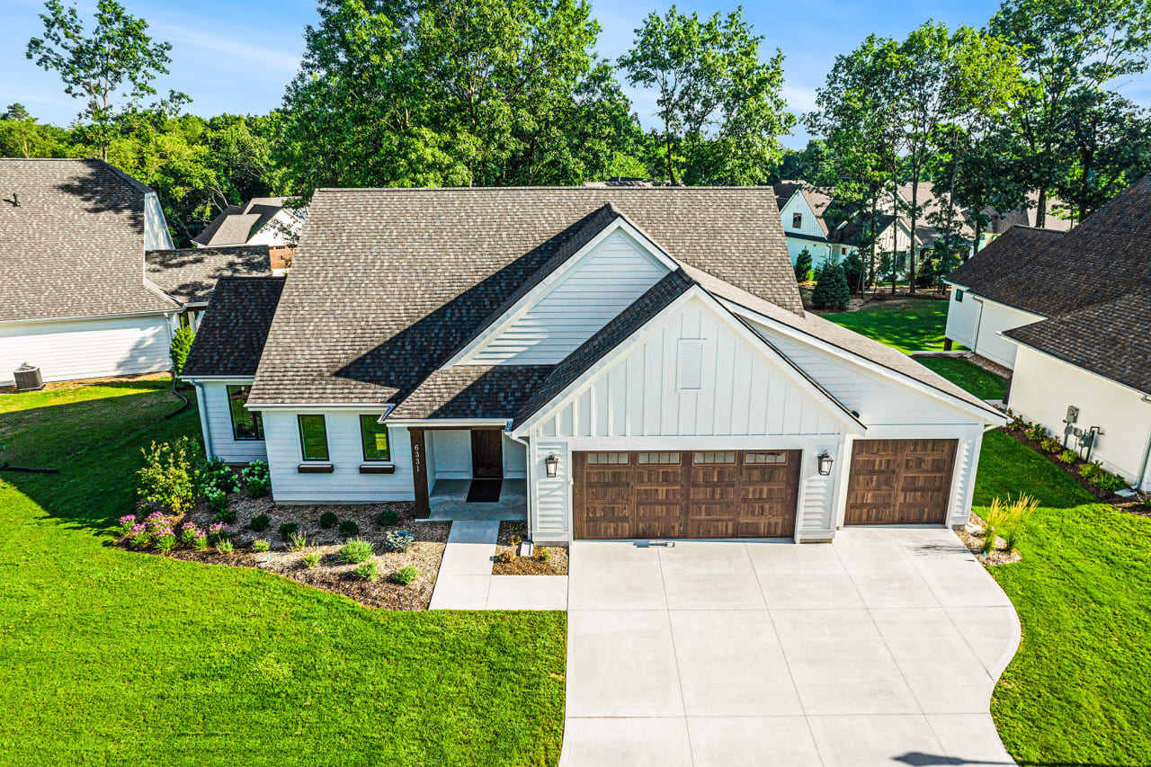 aerial front view of a house with lush green lawn