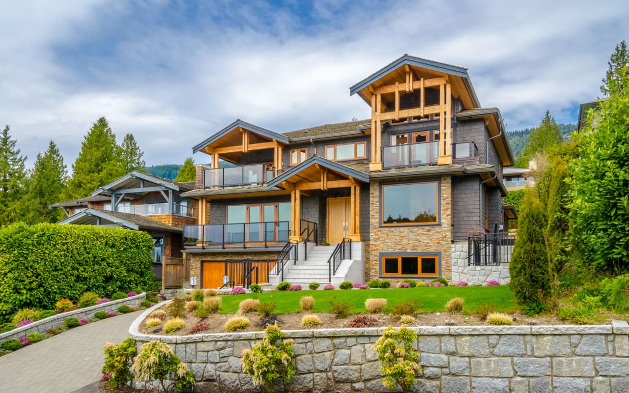 A large house on a hill surrounded by trees.