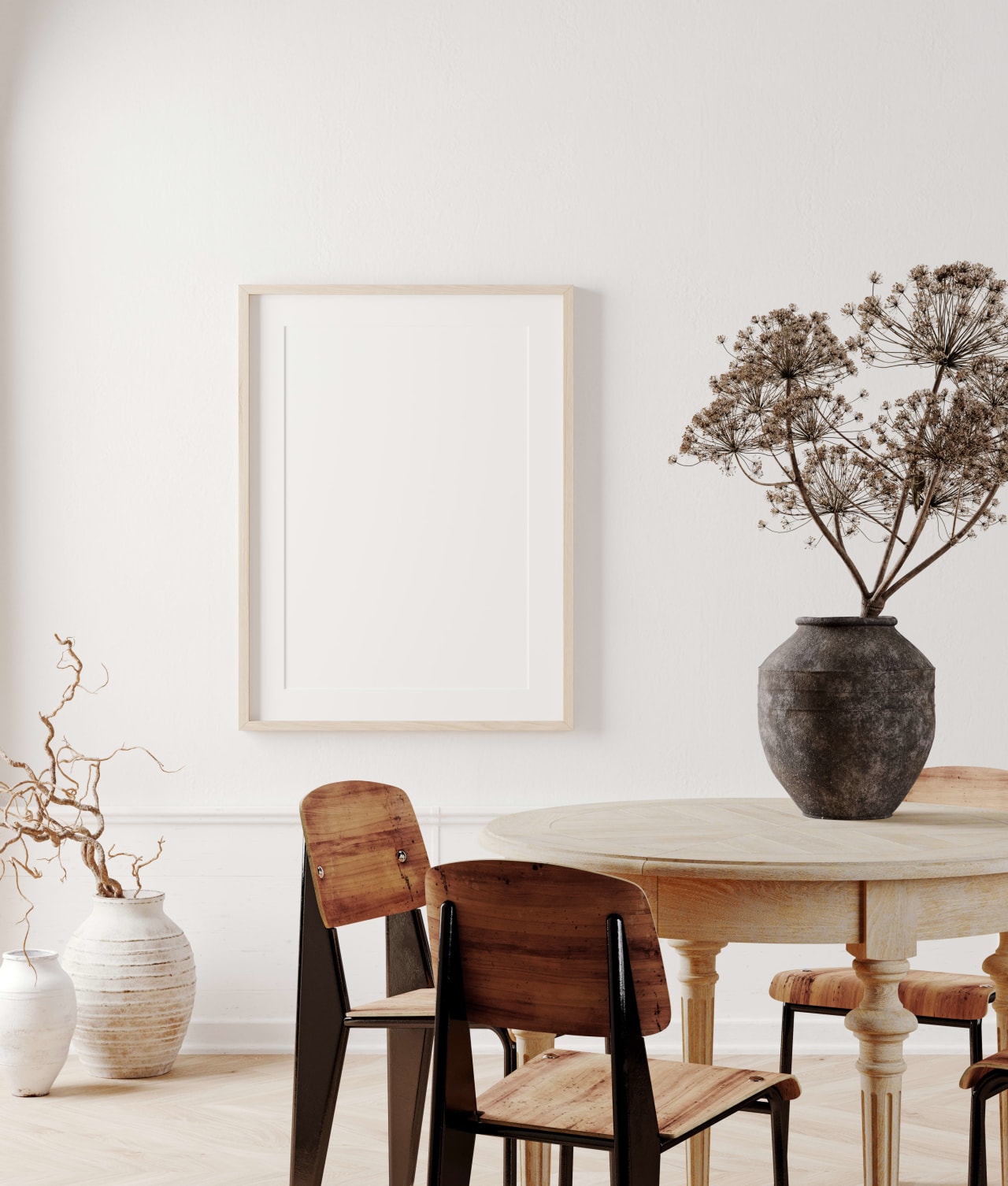 A dining room that has a light wooden table with four chairs, and a vase with flowers in the center.