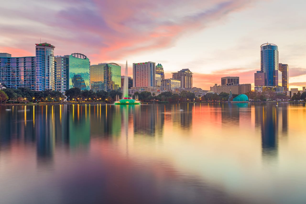 Beautiful sunset reflecting on Lake Eola at downtown Orlando, Florida