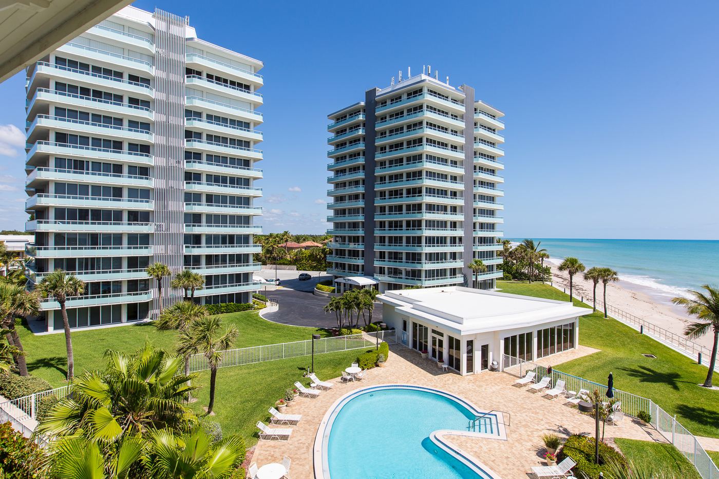 Oceanfront pool, clubhouse, and private beach at Village Spires, Vero Beach