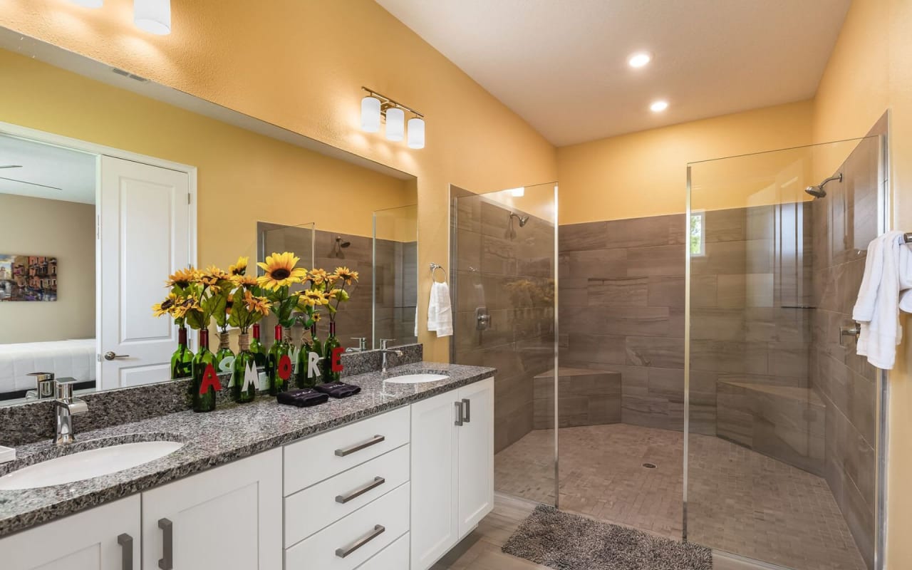 A modern design bathroom with two rectangular sinks with marble countertops and faucets.