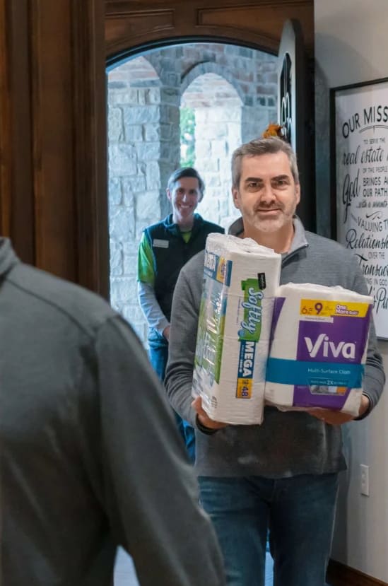 A man holding two piles of tissues