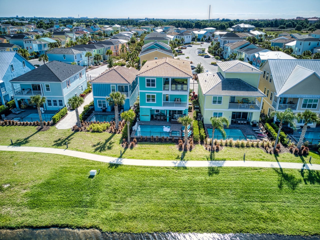 An aerial view of row houses with palm trees and pool on each houses