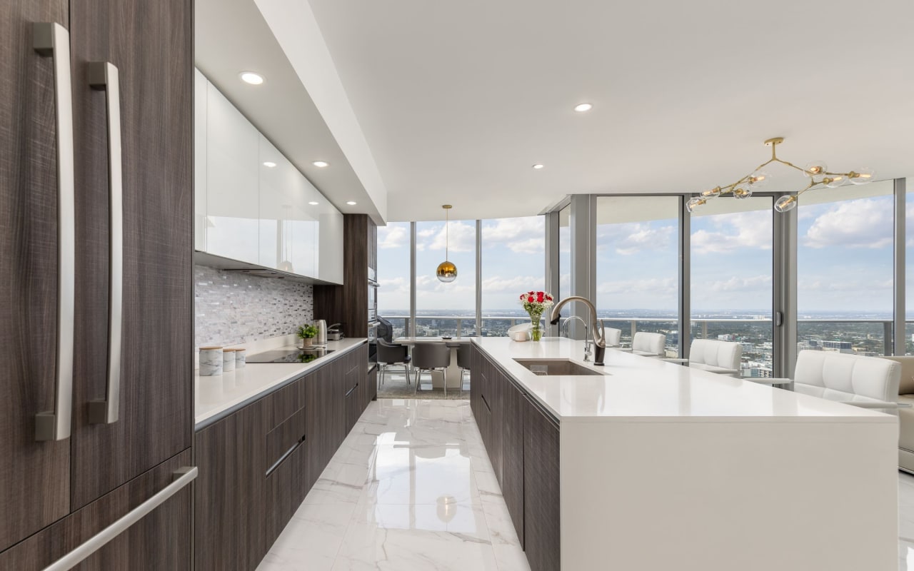 a kitchen with a large window overlooking the city