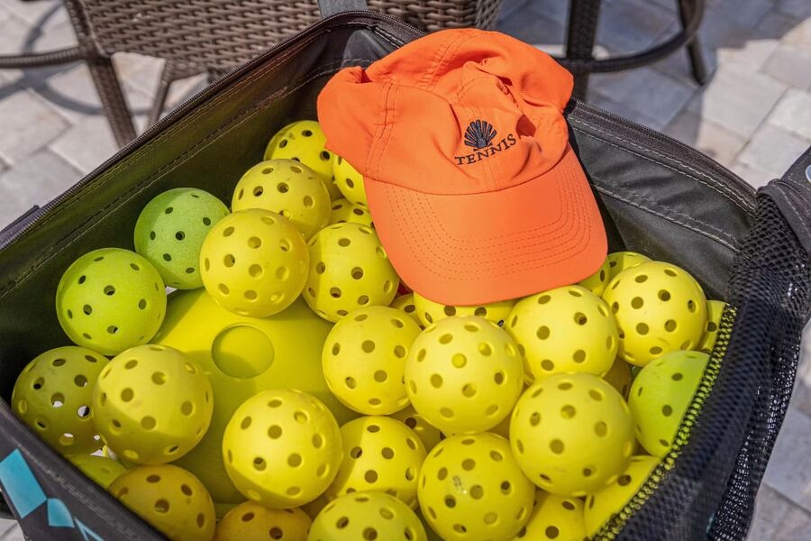Bag of pickleballs courtside at a Vero Beach barrier island club
