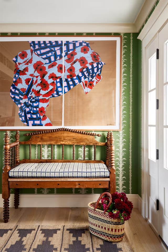 Living space with earthy green wallpaper designed by Elizabeth Hay, reflecting the 2026 shift toward verdant neutrals