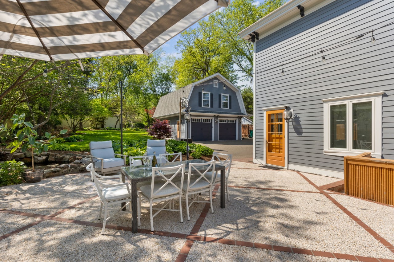 Professionally landscaped outdoor patio with pond.