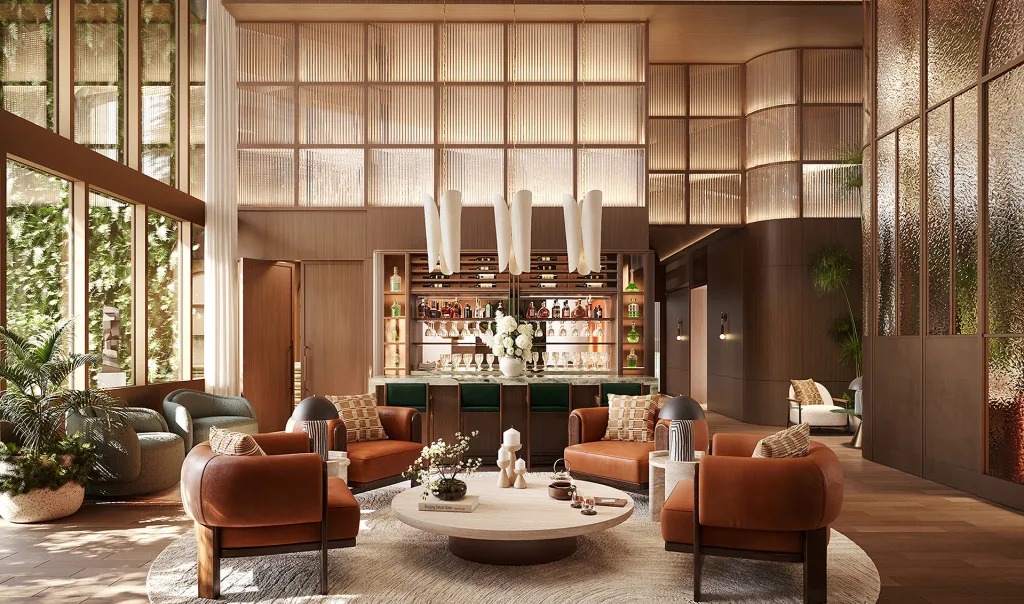Double-height lounge with a stocked bar, rust-colored leather seating, and tall windows.