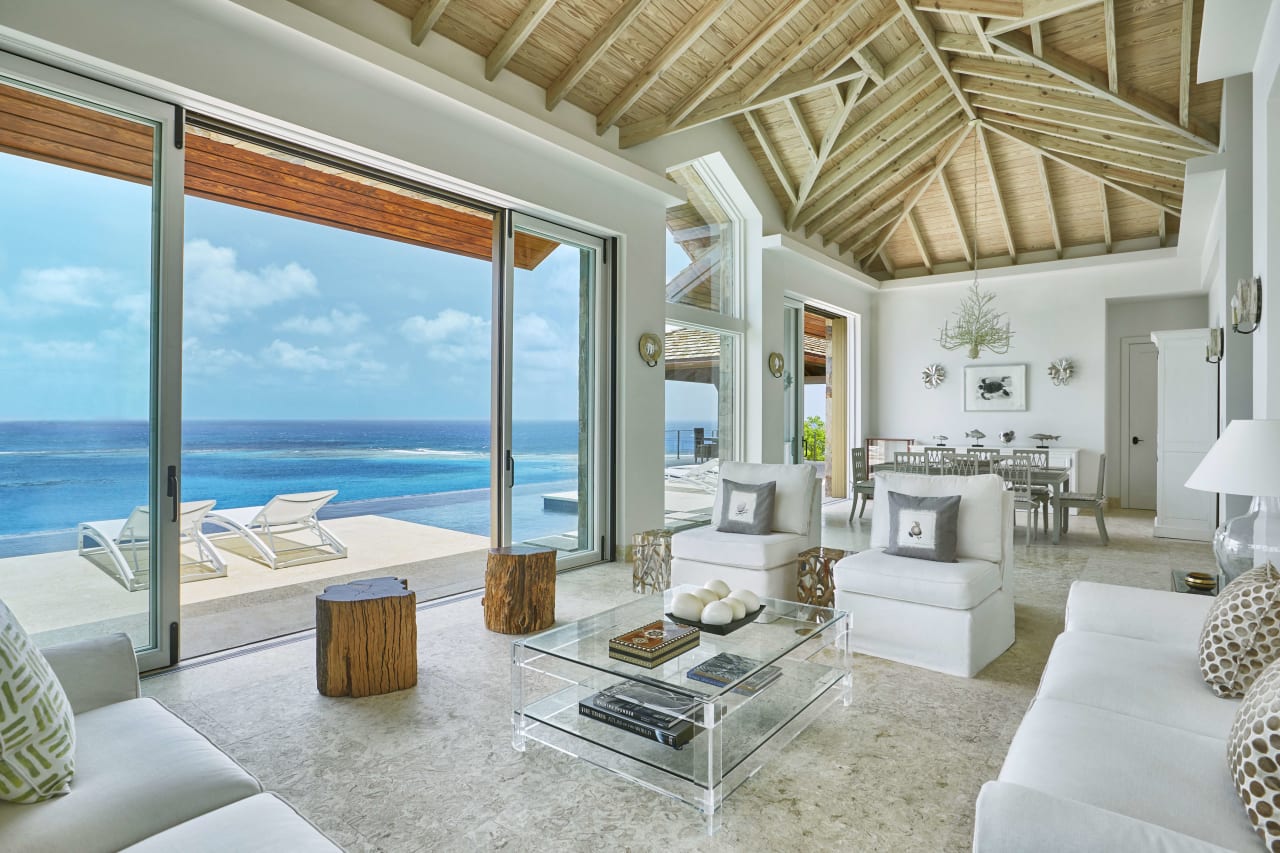 a modern living room with a panoramic view of the ocean