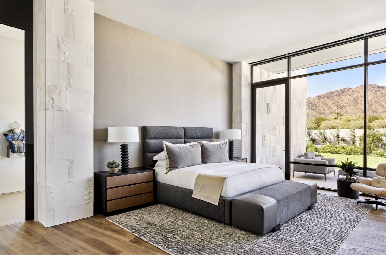 Primary luxury bedroom with floor to ceiling windows