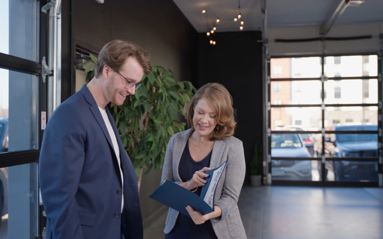 A portrait of Cari Ann Carter discussing with a client.