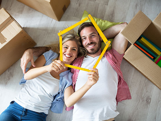 A couple capturing their faces with a pentagon made out of yellow sticks.