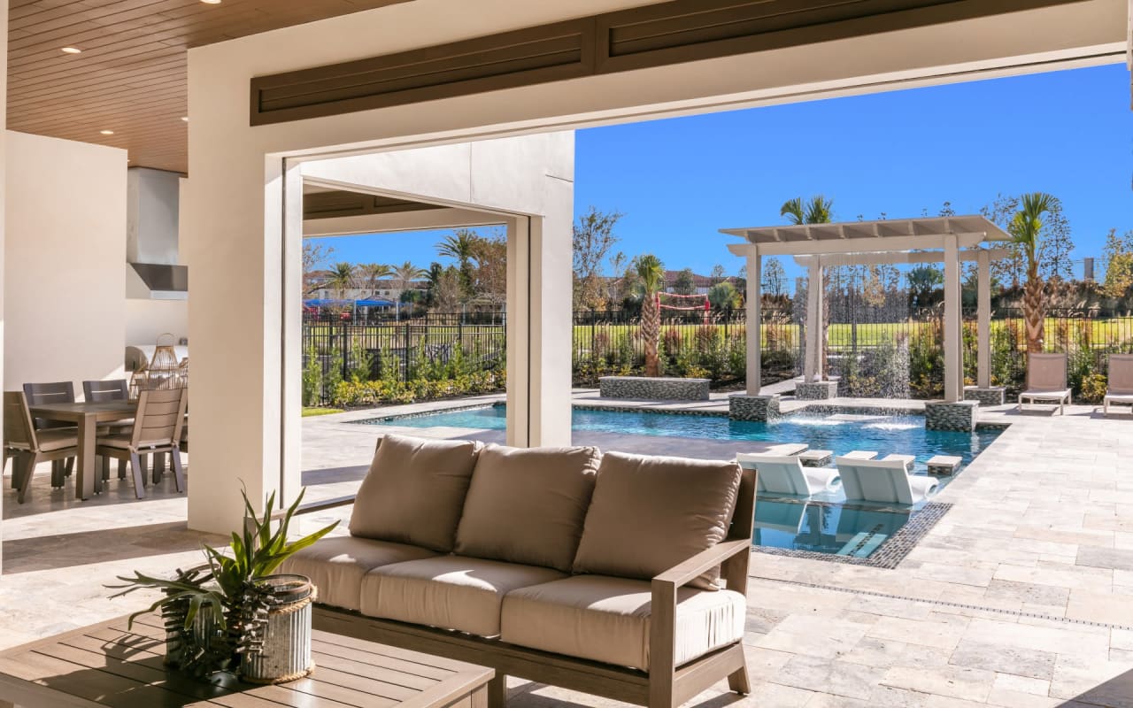 Covered lanai and pool area of a luxury home at The Bear's Den at Reunion Resort