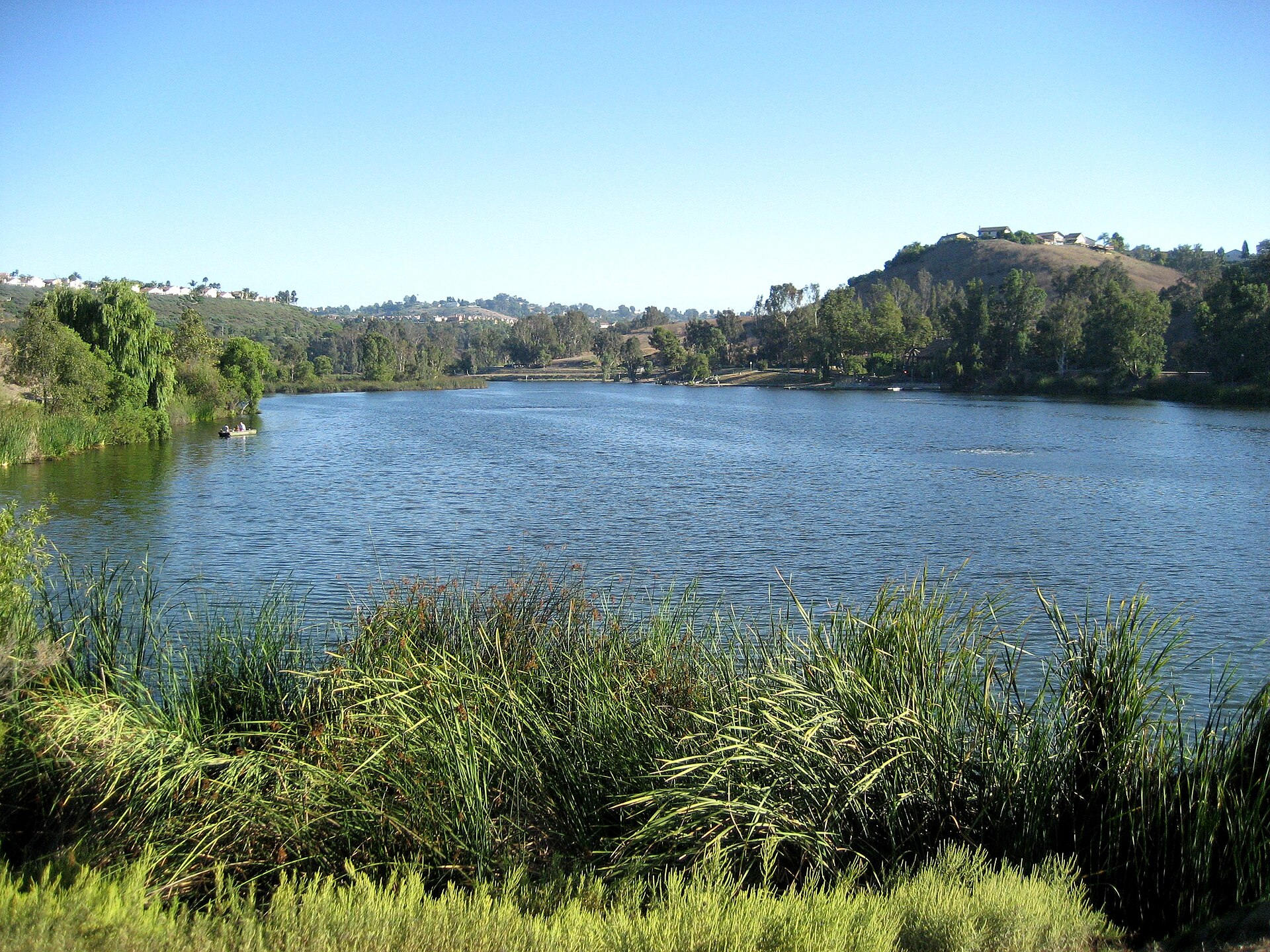 Laguna Niguel Lake bordered by trees and reeds