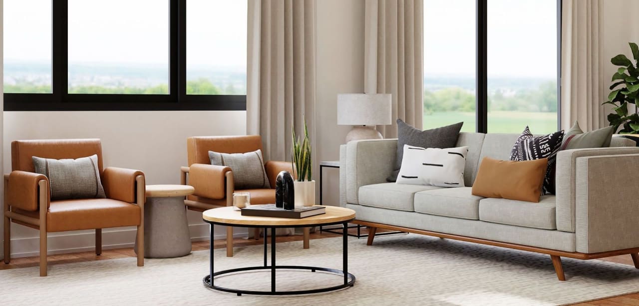 A cozy living room with a large couch, two armchairs, a coffee table, and a rug.