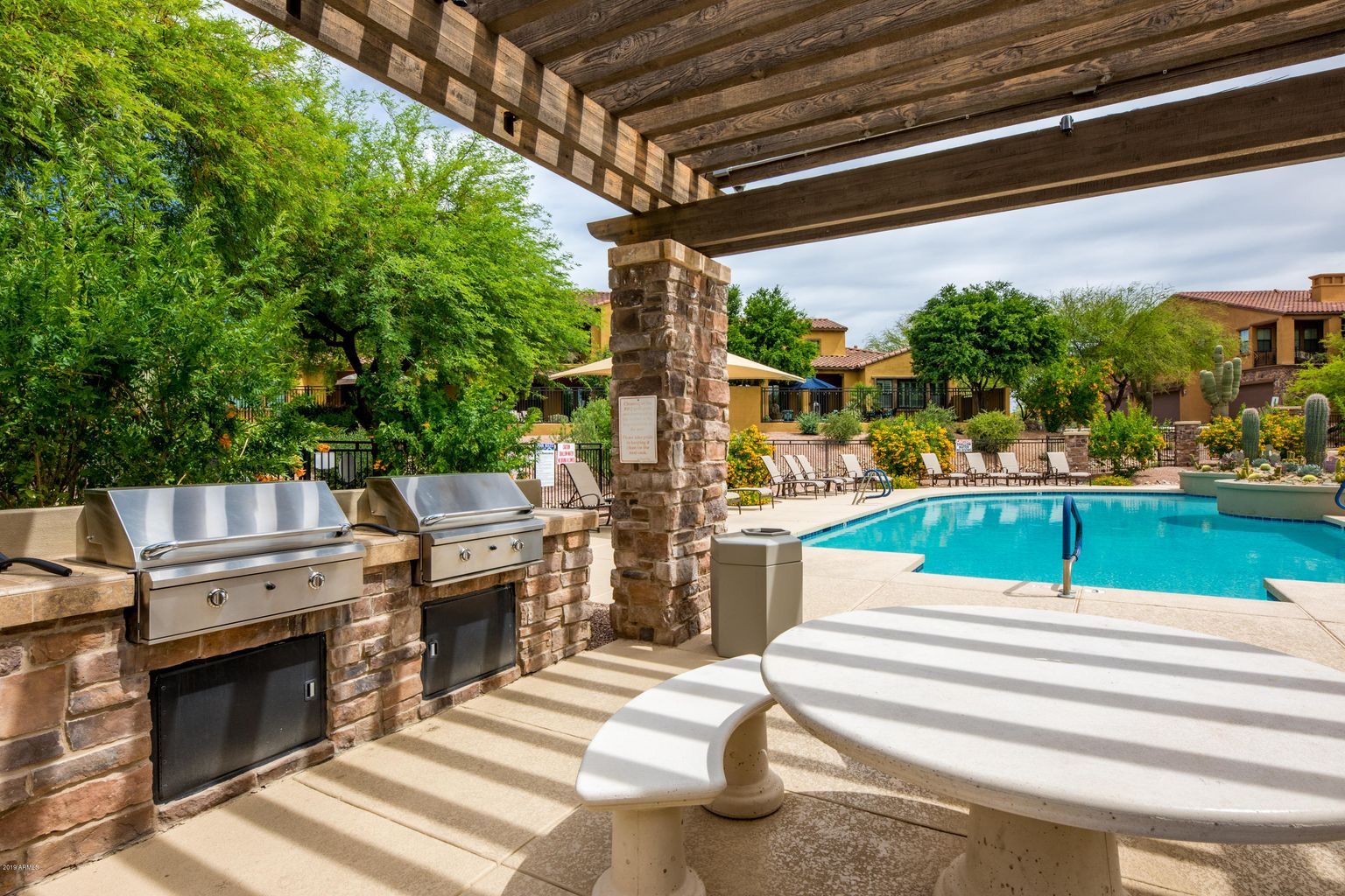 Encore at Grayhawk BBQ area with pool in the background