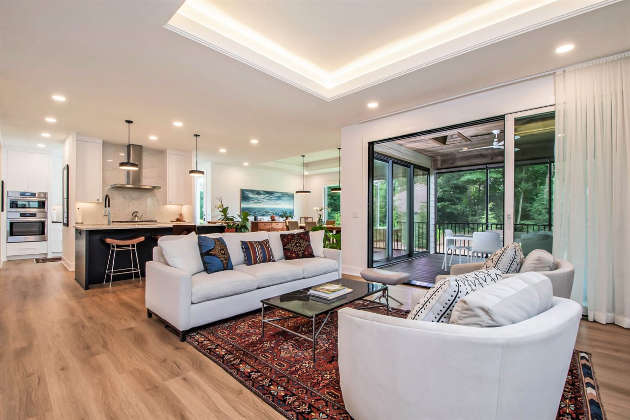 living area couches with kitchen area in the background