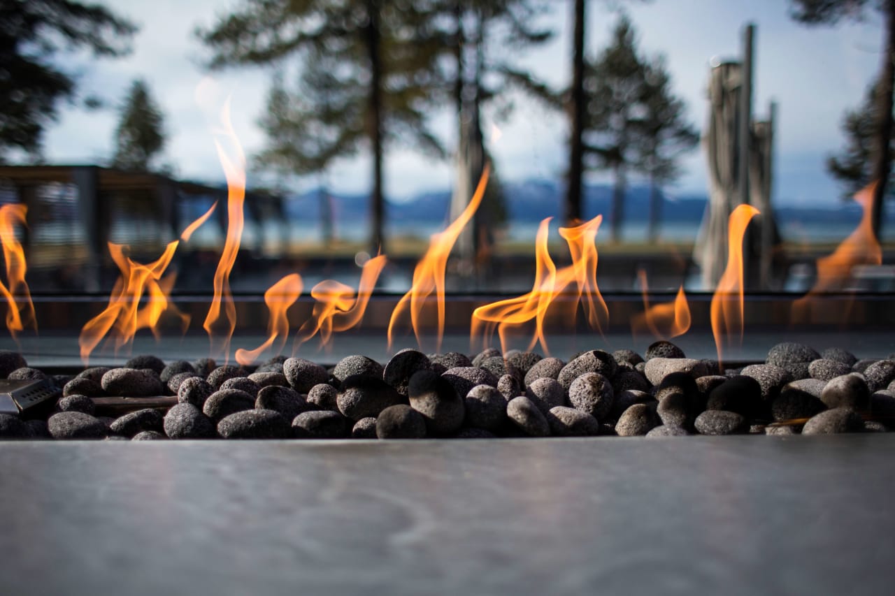 A fire pit with flames burning brightly in the center.