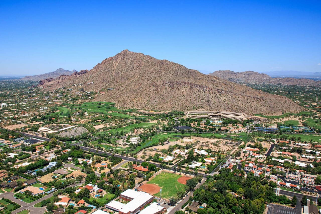 Aerial view of a residential area with a mountain in the background