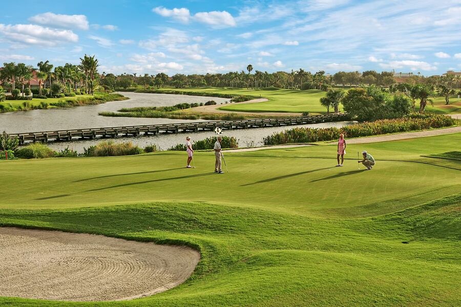Golfers on a manicured green at a Vero Beach, Florida luxury golf community