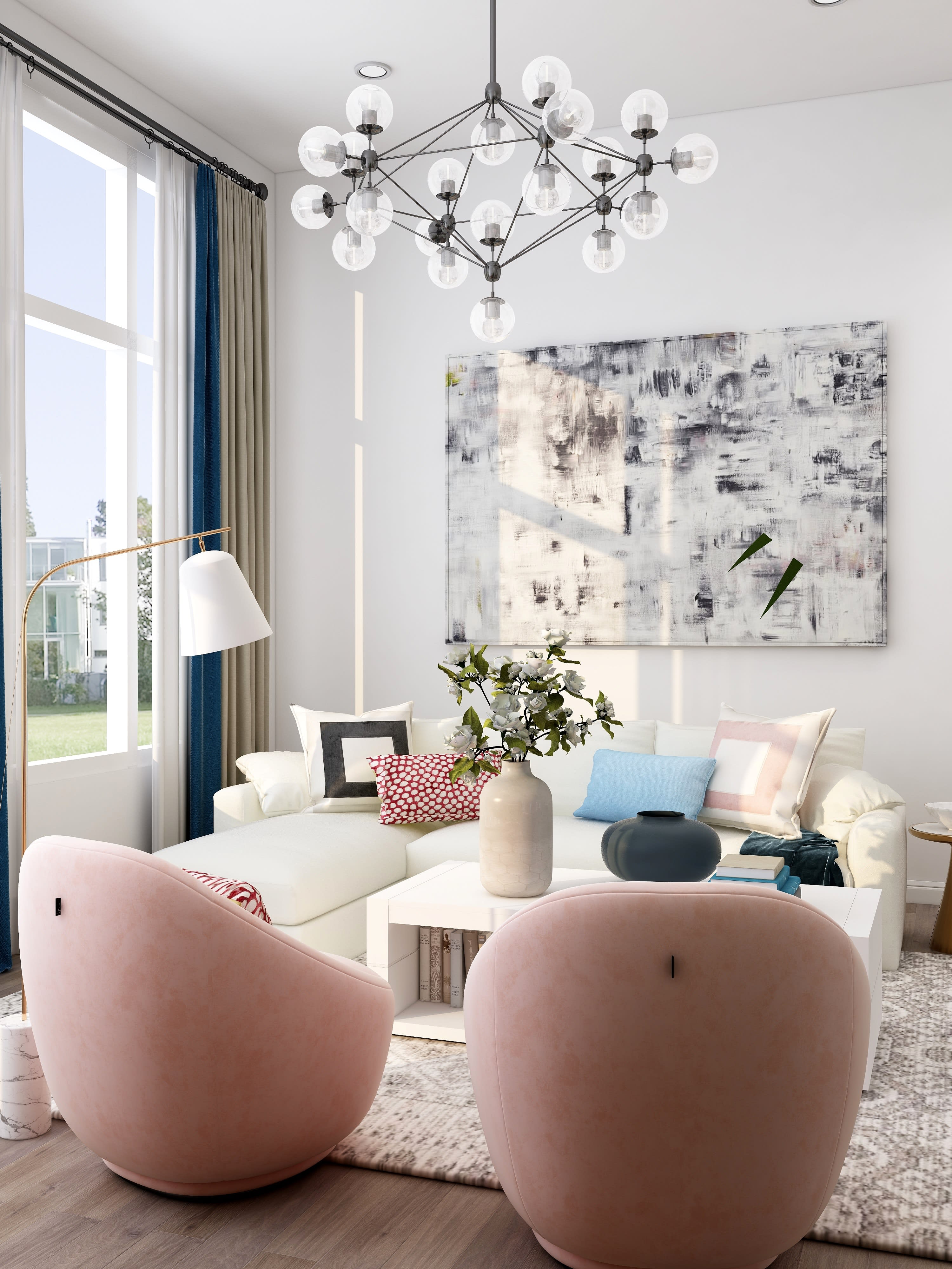 Bright living room with a white sectional, blush armchairs, abstract art, and a globe chandelier.