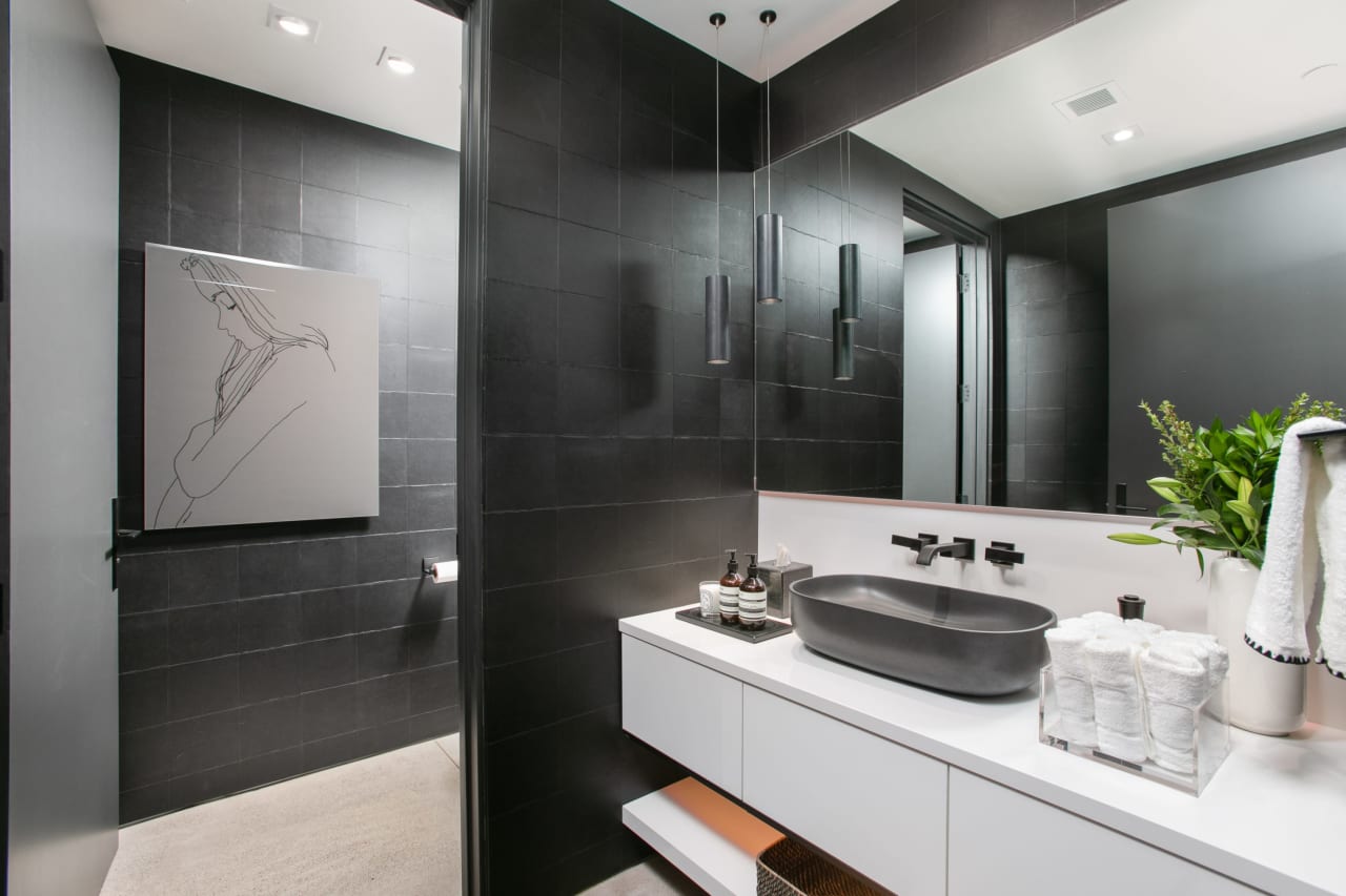 Luxury home with modern powder room and black accents