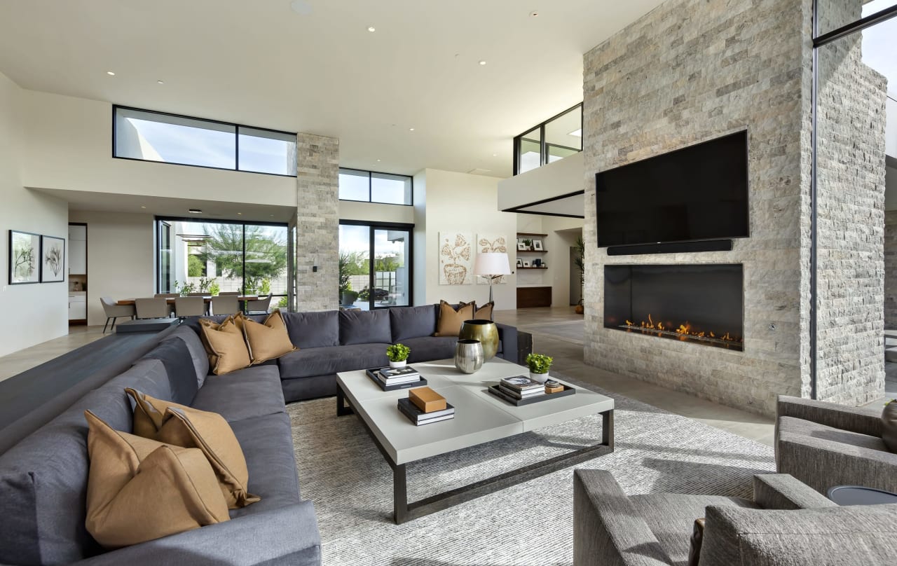 Modern living room with natural light and stone fireplace