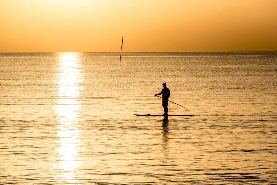 Paddleboarder at sunrise on the Indian River Lagoon in Vero Beach, Florida