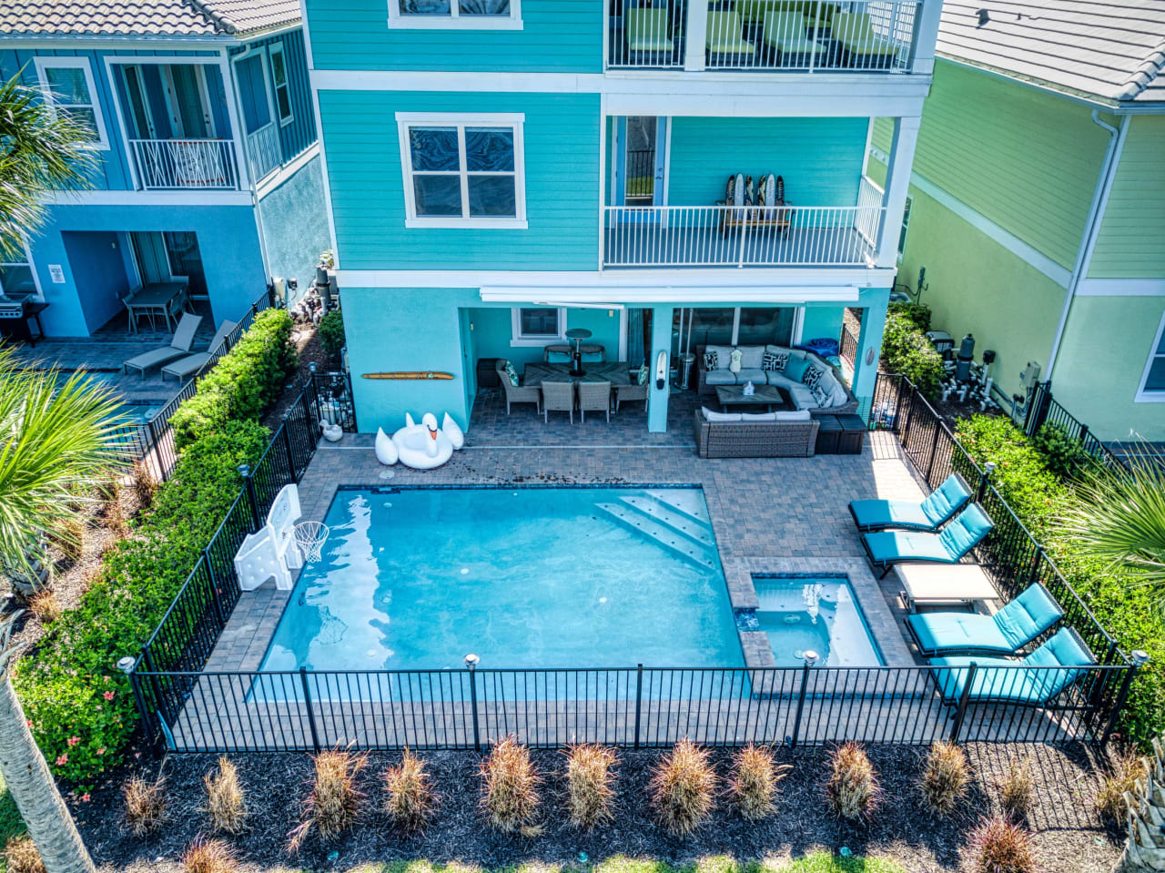 A bird's-eye view of a residential property with a swimming pool.