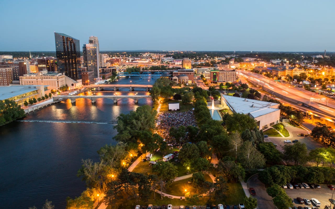 Photo of Buildings, Trees, and River with Orange Color Lights