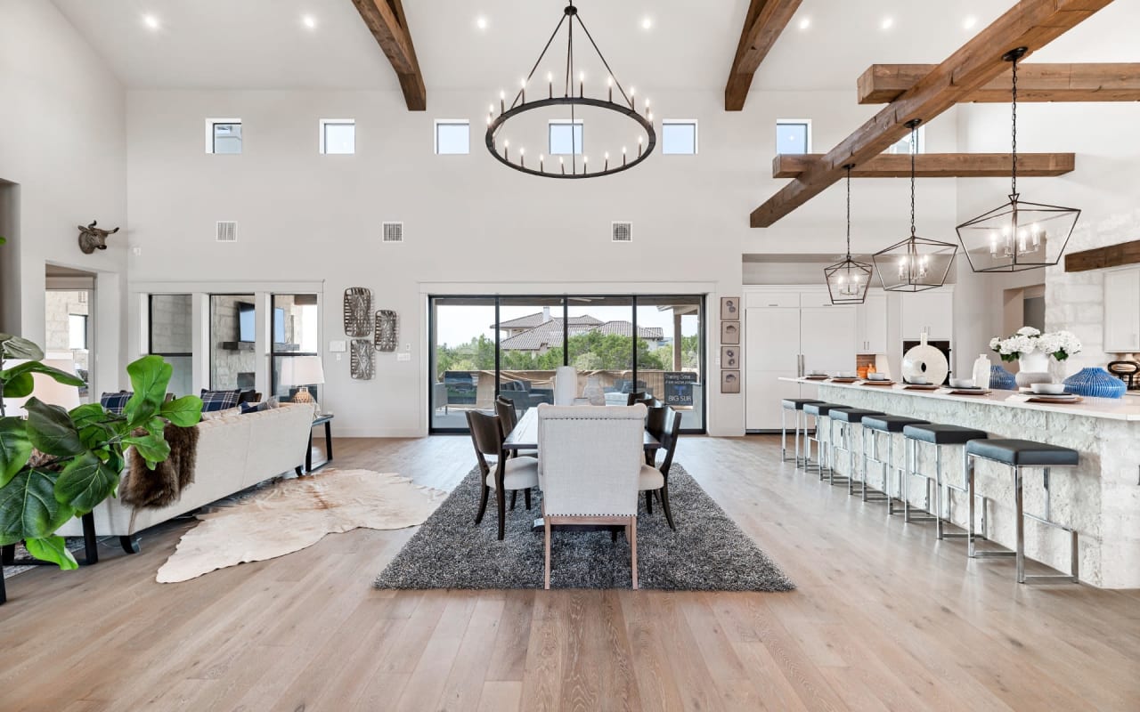 A spacious dining room with a large wooden table and chairs.