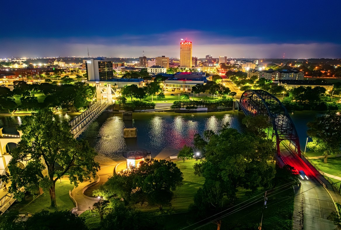 Downtown Waco skyline at dusk with the ALICO building and the Brazos River