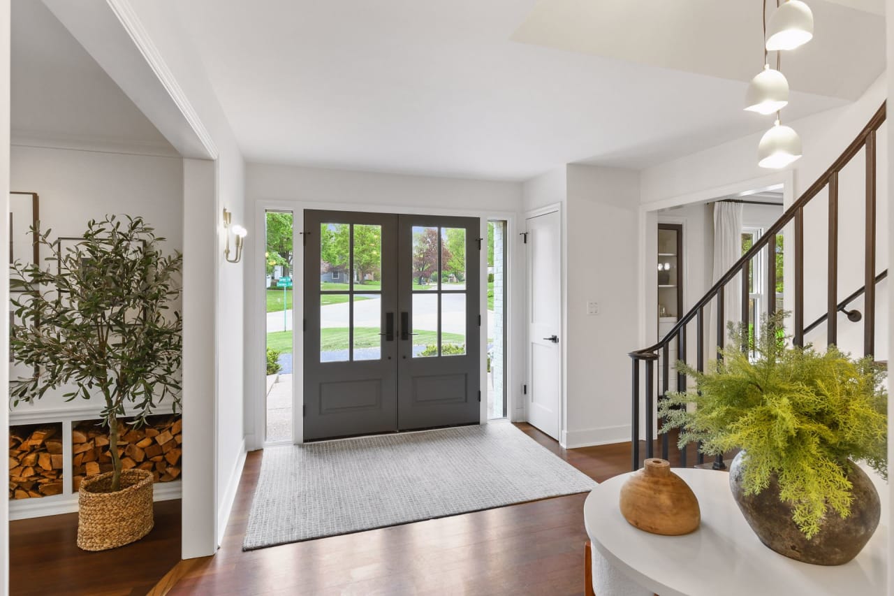 A spacious hallway with a grand staircase leading up to the second floor.