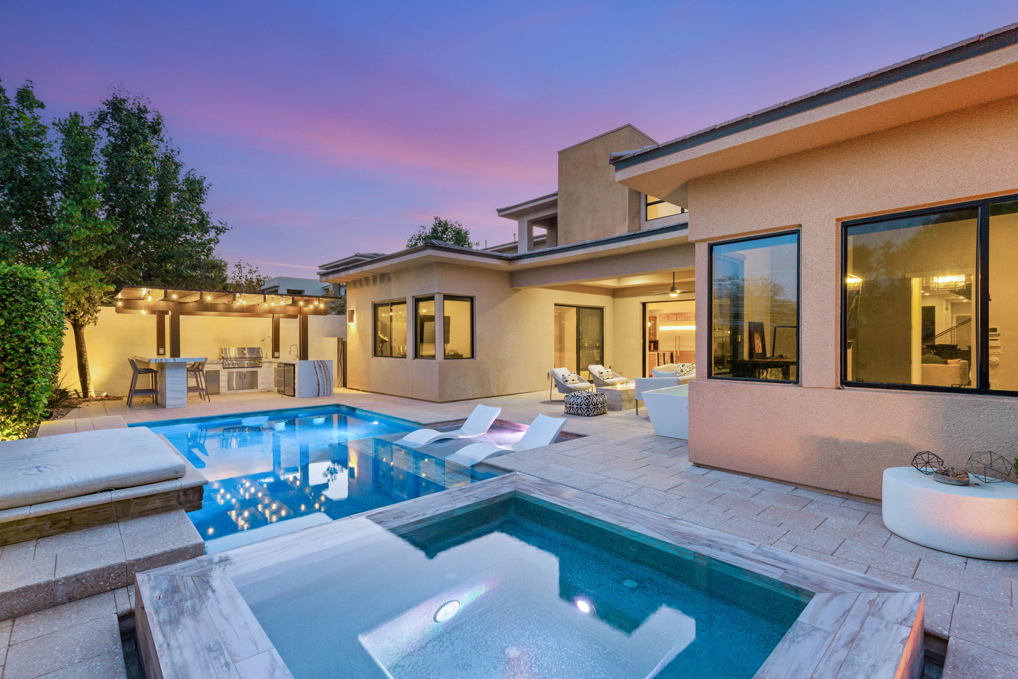 Resort-style pool and covered patio at twilight at a luxury home in The Ridges, Summerlin, Las Vegas