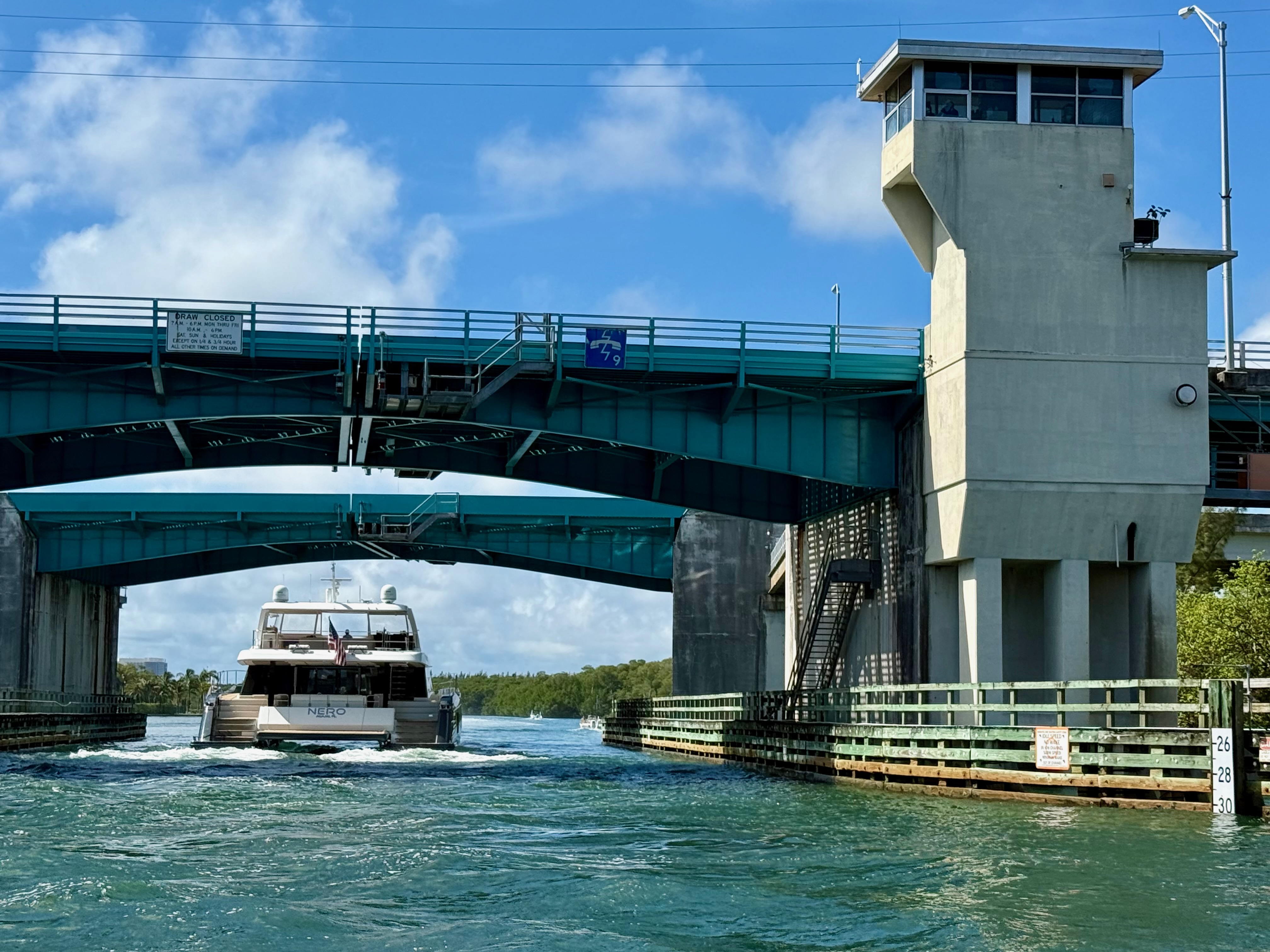 A large 60ft power catamaran successfully clearing the 163rd St Bascule Bridge in North Miami Beach demonstrating vertical clearance for Eastern Shores residents