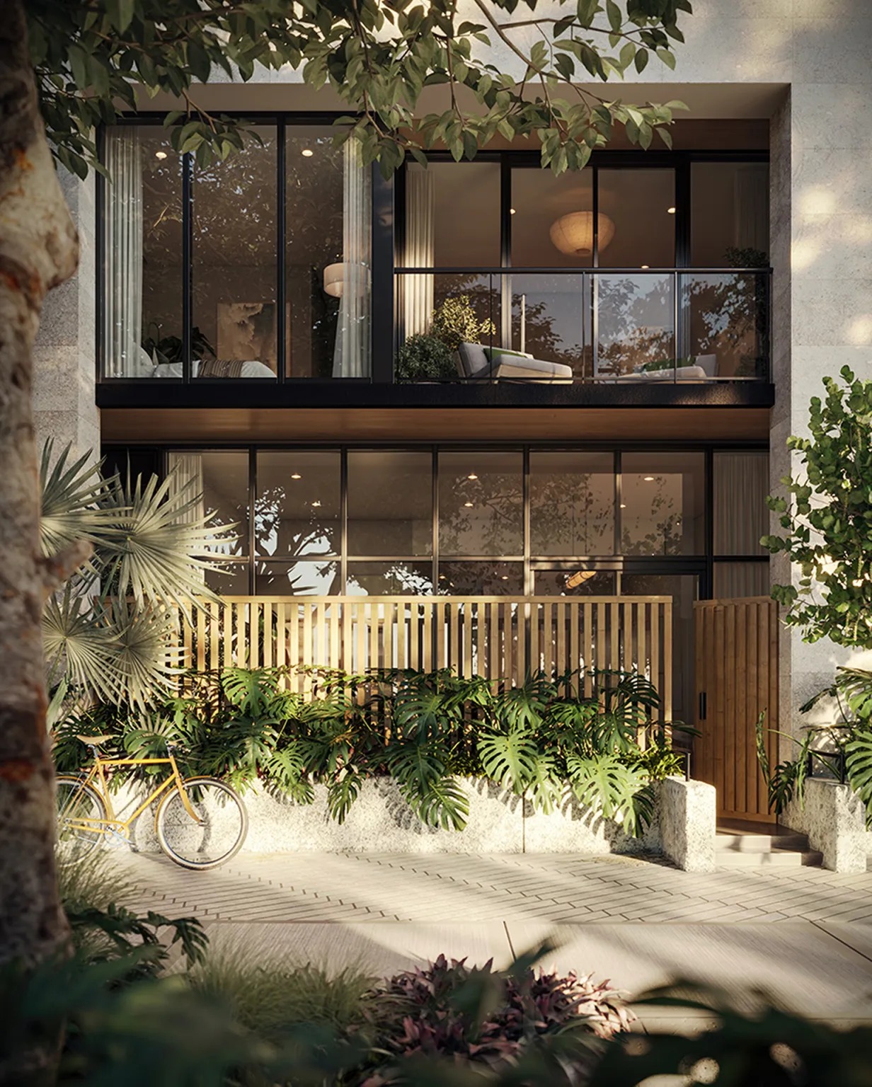 Modern glass-fronted residence with a furnished balcony, tropical plants, and a bicycle by the entrance.